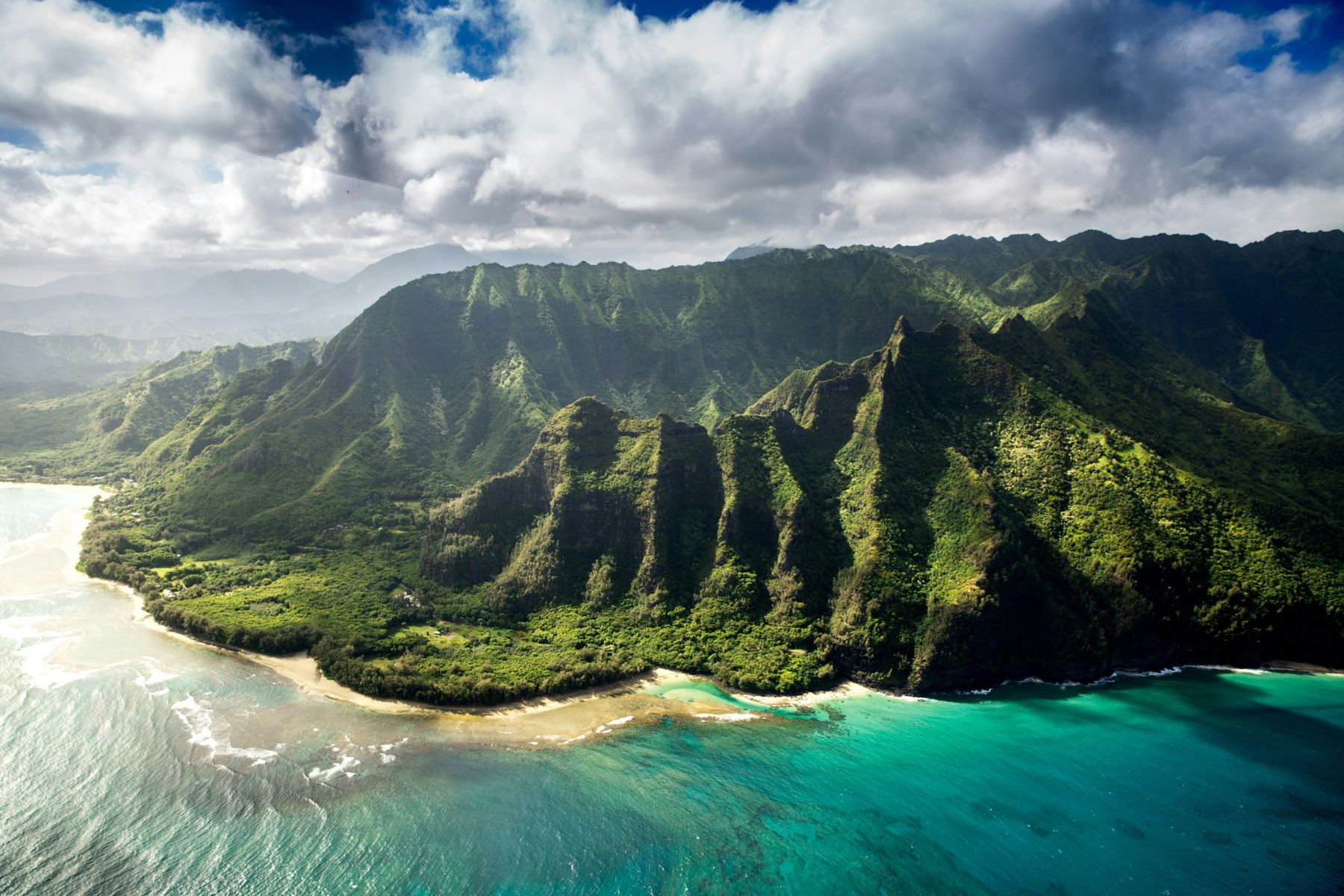 Green mountains above the reef on Kauai's north shore